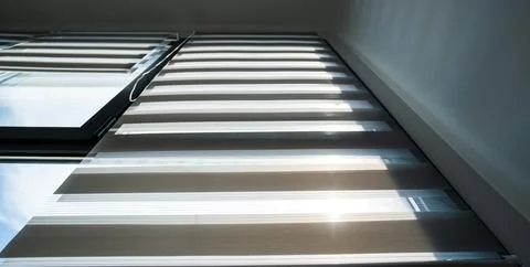 Day night roller blinds installed on large window in modern apartment 写真素材