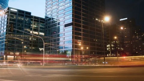Day night split time-lapse rush hour, light trails headlights office buildings Stock Footage 308670757