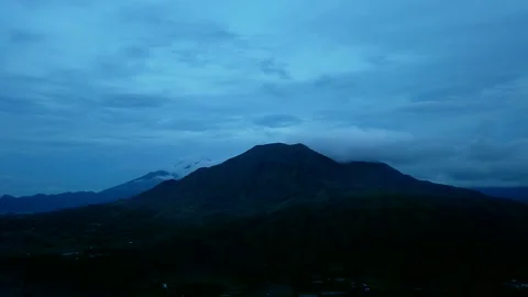 Day to night time lapse, Agung Mount at sunset. Clouds blue sky. Pan right Stock Footage 141122467