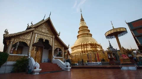 Day to night time lapse of golden pagoda at Thai temple, Lamphun, Thailand Stock Footage 73045651