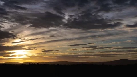 Day to night time lapse of stratocumulus clouds rolling through sky Stock Footage 244155261