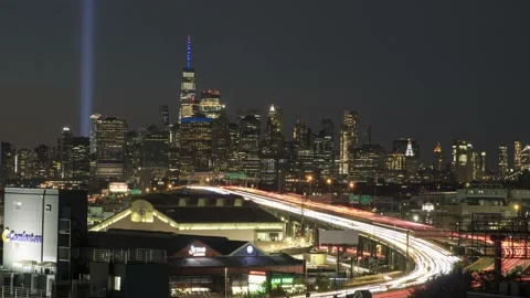 Day to night time lapse of traffic with the One World Trade 9/11 Tribute Lights Stock Footage