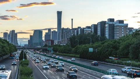 Day-to-night time-lapse video of CBD building traffic flow on the road in the ev Stock Footage 246076265