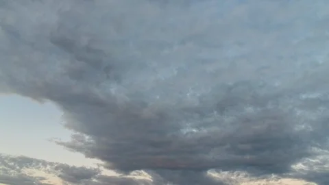 Day to night timelapse of the fast-moving clouds at sunset and blue hour Stock Footage 120283676