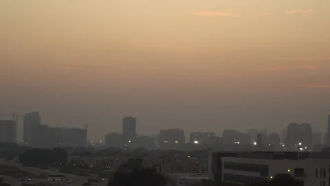 Day to night Timelapse of sunset over dubai city suburb in the orange sky Stock Footage 220726399