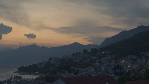 Day to night transition time lapse over Baska Voda resort town in Croatia Video stock 345972989