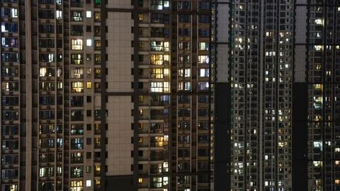 Day to night transition Timelapse of light in windows of a modern city building Stock Footage