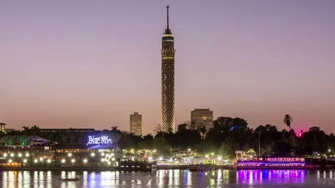 Day to night video of Cairo tower and Nile river. Illumination switch on. Stock Footage 124754995