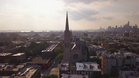 Day orbiting clockwise around church in Park Slope Brooklyn revealing Manhattan  Vídeos de archivo 78260655