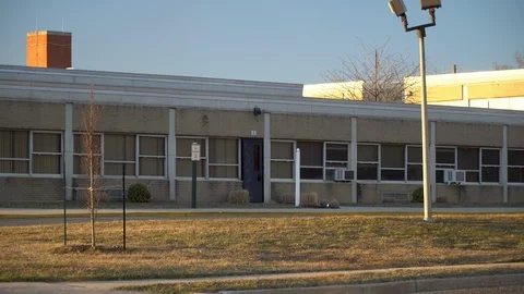 Day school exterior establishing 4k video shot. DX elementary building Stock Footage
