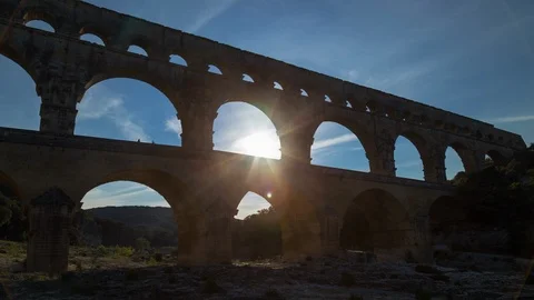 Day time lapse with sun of an old roman bridge, pont du gard aqueduct Stock Footage 95945915