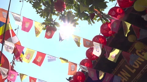 Day time look up rotate flags buddhist temple sun flare Видео 271062120