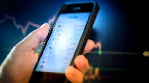 Day trader using phone Stock Photos