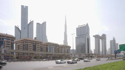 Day traffic of Sheikh Zayed Road. The Burj Khalifa Tower Video stock 100741670