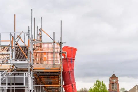 Day view building under construction with scaffolding in England Photos