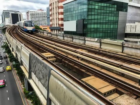 Day view of Electric Sky Train running on the rail tracks in downtown Bangkok Stock Photos