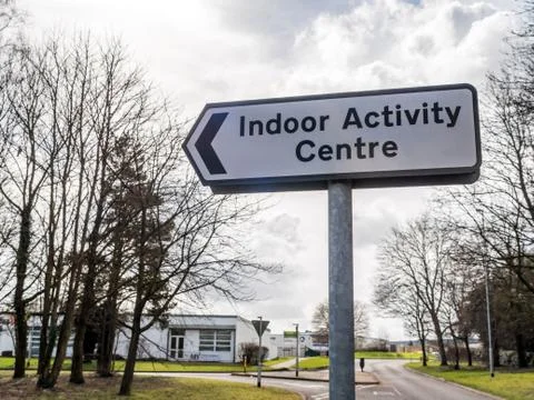 Day view Indoor Activity Centre directional road sign post on british road Stock-Fotos
