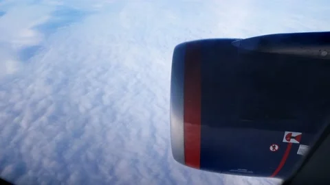 Daybreak aboard a passenger plane flying above the clouds. Stock Footage 167646319