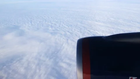 Daybreak aboard a passenger plane flying above the clouds. Stock Footage 167714059