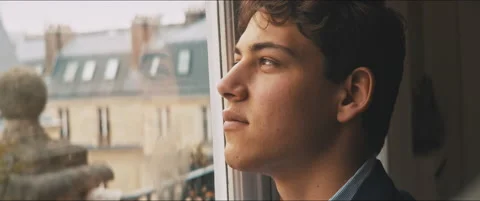 Daydreaming young man staring at the cloudy sky from his home Video stock 203586286