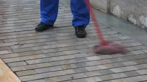 Daylight 4k close up shot of a janitor mopping the sidewalk of a building. Stock Footage 122645864