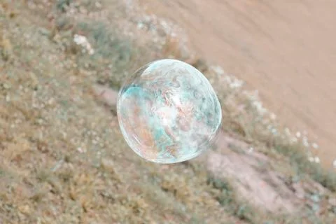 Daylight. big soap bubble flies. there is toning. Stock Photos