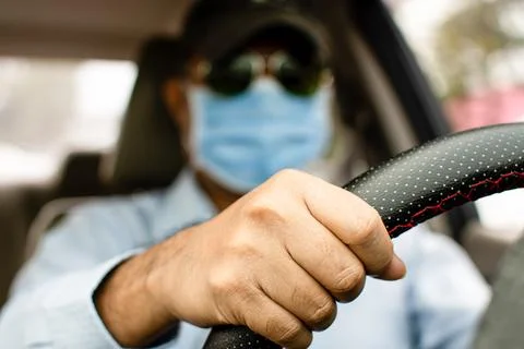 Daylight a man driving two hands to hold the steering wheel to control the .. Stock Photos