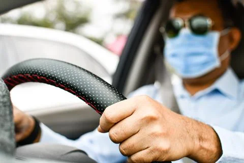 Daylight a man driving two hands to hold the steering wheel to control the .. Stock Photos