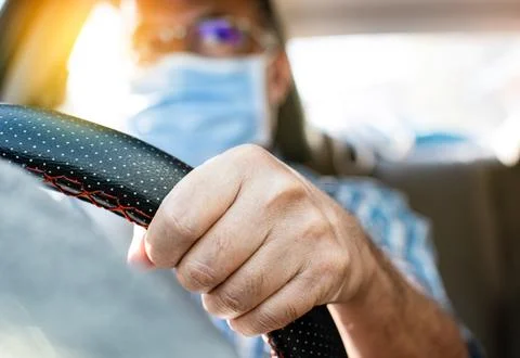 Daylight a man driving two hands to hold the steering wheel to control the .. Foto stock
