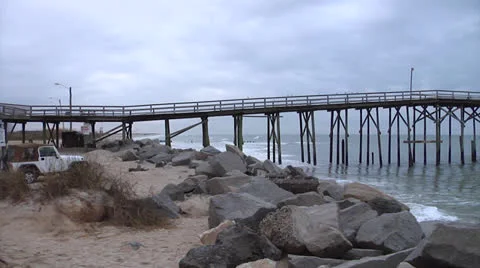 Daylight pan of pier and waves Stock Footage 24416581