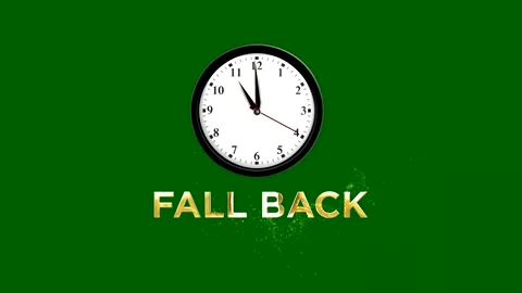 Daylight saving time concept with analog wall clock and golden fall back te.. Stock Footage 346542427