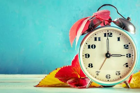 Daylight Saving Time concept, DST, fall back in autumn. A vintage alarm clock Stock Photos