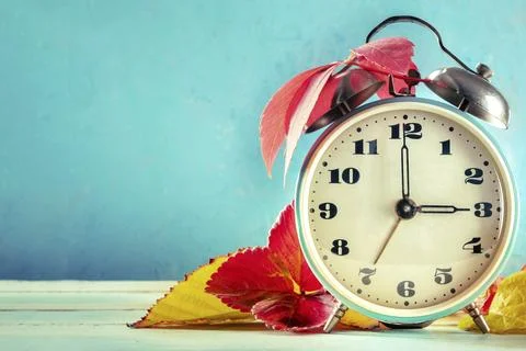 Daylight Saving Time concept, DST, fall back in autumn. A vintage alarm clock Stock Photos