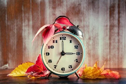 Daylight Saving Time concept, fall back in autumn. A vintage alarm clock Stock Photos