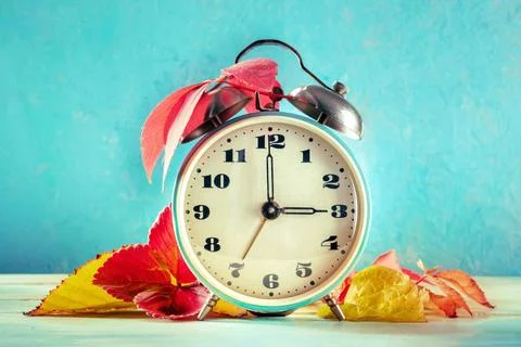 Daylight Saving Time concept, fall back in autumn. A vintage alarm clock D... Stock Photos