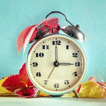Daylight Saving Time concept, fall back in autumn, square image. A retro alarm 스톡 사진