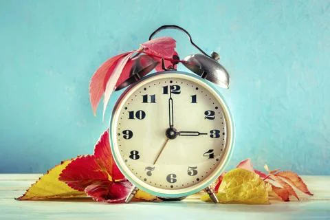 Daylight Saving Time concept, fall back in autumn. A vintage alarm clock with Stock Photos