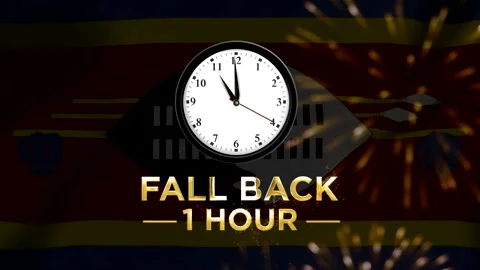 Daylight saving time concept featuring a wall clock with text fall back one.. 스톡 동영상 346542039