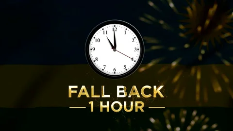 Daylight saving time concept featuring a wall clock with text fall back one.. Stock-Footage 346542041