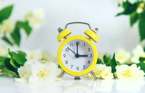 Daylight saving time concept with flowers. Selective focus. 写真素材