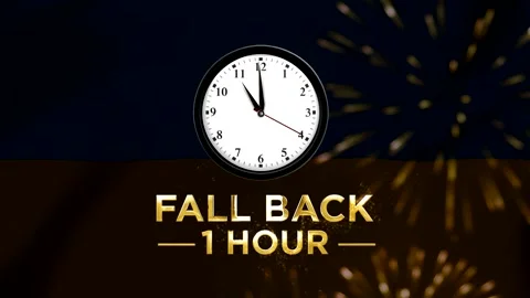 Daylight saving time concept showing a wall clock with text fall back one hou 스톡 동영상 346542128