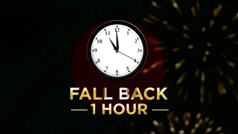 Daylight saving time concept showing a wall clock with text fall back one h.. Stock Footage 346542131