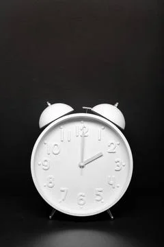 Daylight saving time concept. White Retro clock isolated on black backgrou... Foto stock
