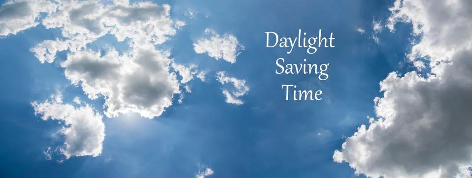 Daylight Saving Time (DST). Blue sky with white clouds and clock. Turn time f Stock Photos