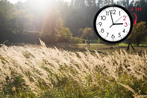 Daylight Saving Time (DST). Blue sky with white clouds and clock. Turn time f Foto stock