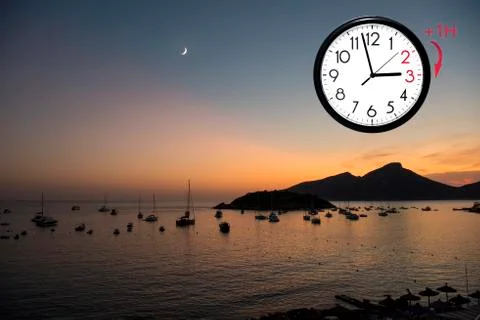 Daylight Saving Time (DST). Blue sky with white clouds and clock. Turn time f Stock Photos