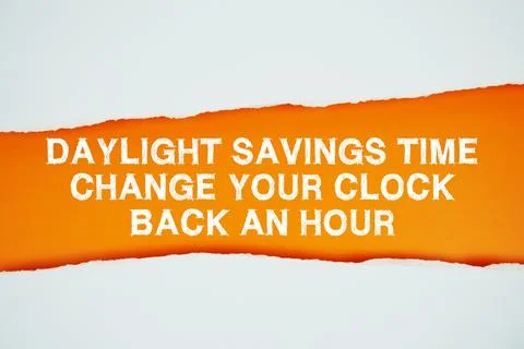 Daylight Saving Time text on orange with white paper torn ripped of horizonta Stock Photos
