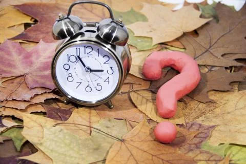 Daylight Saving Time. Wall Clock going to winter time. Autumn abstraction. Stock Photos