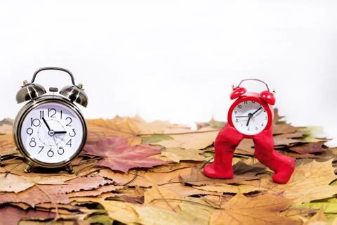 Daylight Saving Time. Wall Clock going to winter time. Autumn abstraction. Stock Photos