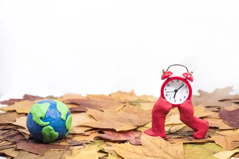 Daylight Saving Time. Wall Clock going to winter time. Autumn abstraction. Stock Photos